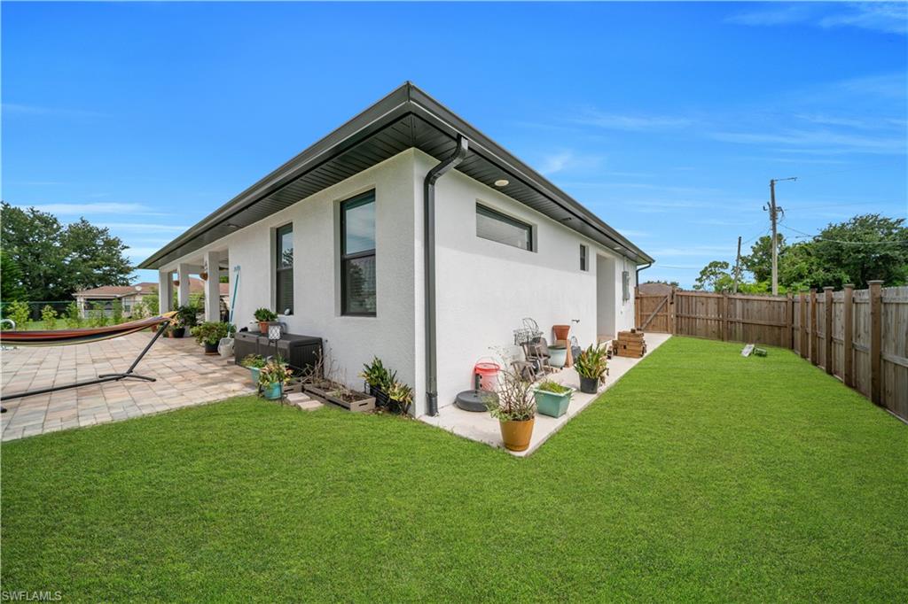 Expansive green lawn bordering a stucco exterior