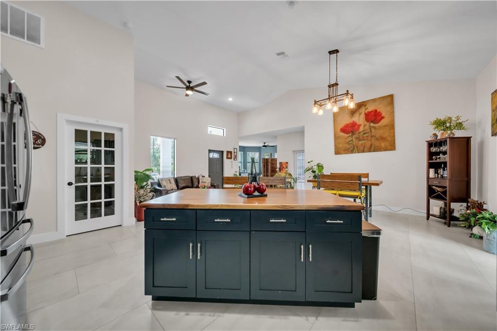 Spacious kitchen island with a wood-finish countertop and dark cabinetry