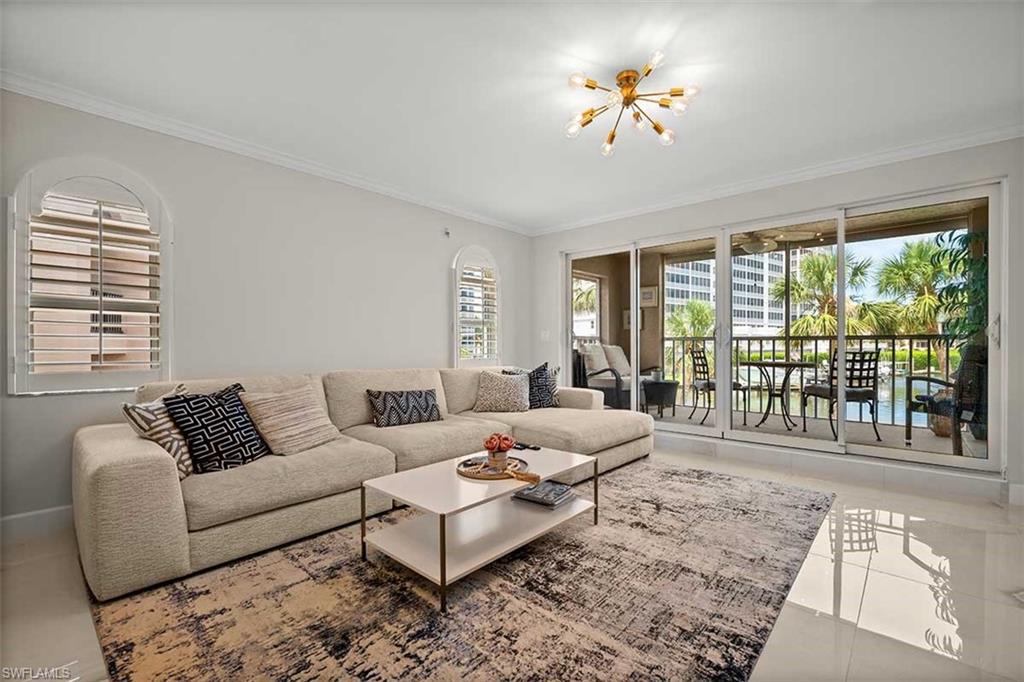 Living area featuring large sliding glass doors opening to a private balcony