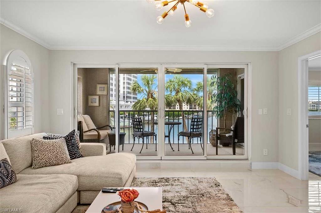 Sliding glass doors opening to a private balcony with water frontage