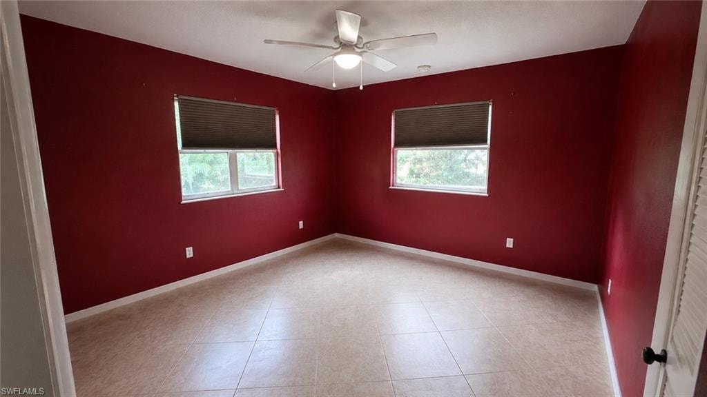Interior space featuring bold red walls and neutral-toned tile flooring