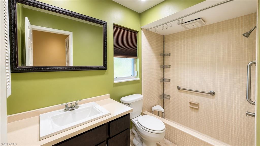 Bathroom featuring a vanity with an integrated sink and a large framed mirror