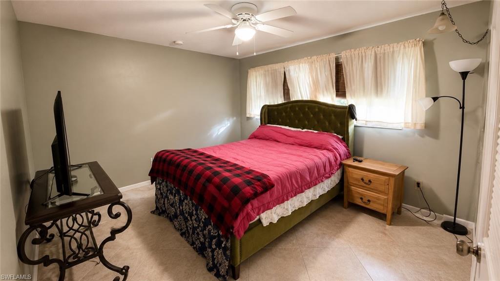 Neutral wall paint, ceiling fan, and light-colored tile flooring create a bright atmosphere