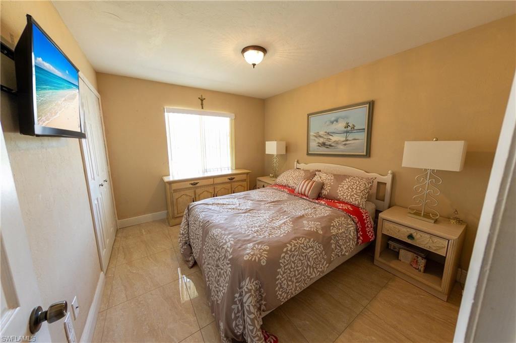 Bedroom featuring baseboards and light tile patterned flooring