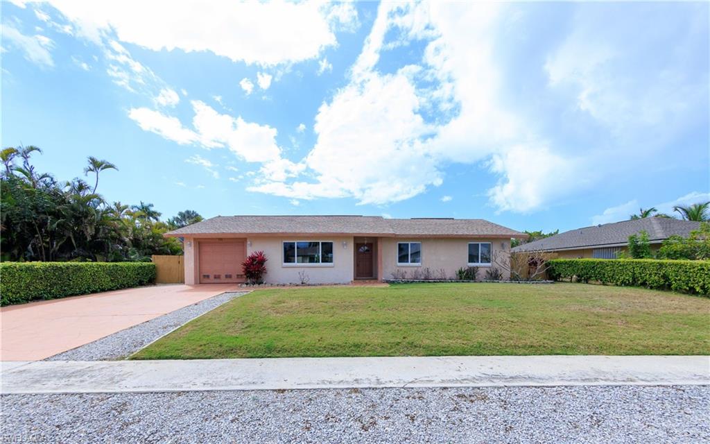 Ranch-style house featuring concrete driveway, stucco siding, and an attached garage