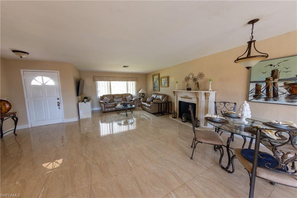 Dining area with a fireplace and baseboards