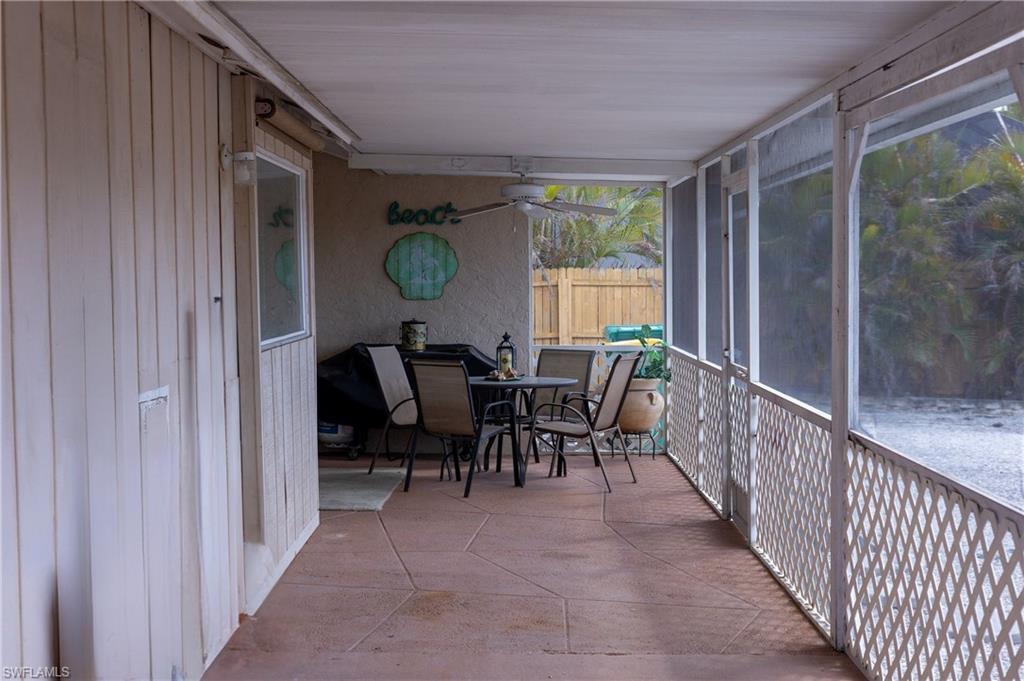 Sunroom with outdoor dining space and ceiling fan
