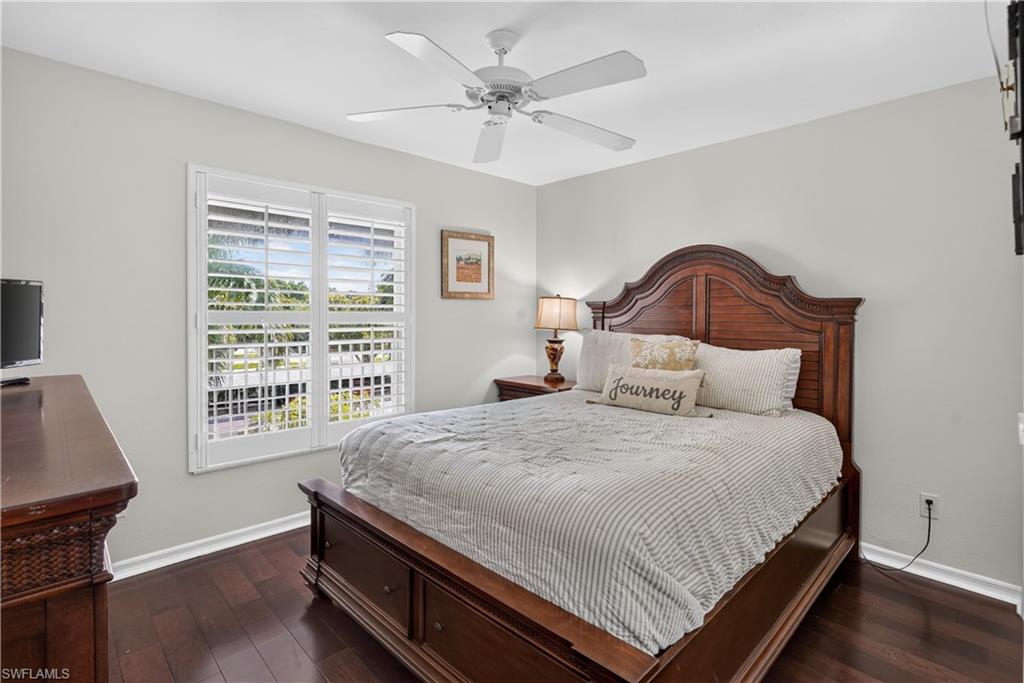 Hardwood-finish flooring, plantation shutters, and a ceiling fan with integrated lighting