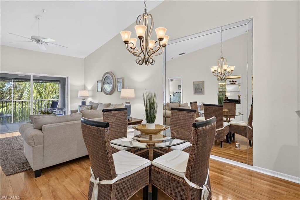 Vaulted ceilings, wood-finish flooring, and a decorative chandelier