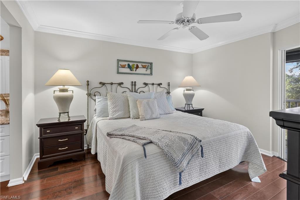 Wood-finish flooring, crown molding, ceiling fan, and a built-in balcony door