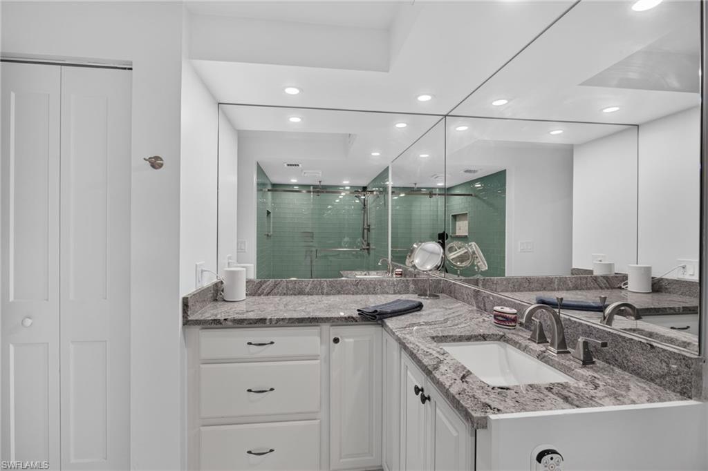 Large new vanity with plenty of space, custom plumbing and lighting fixtures. Linen closet.