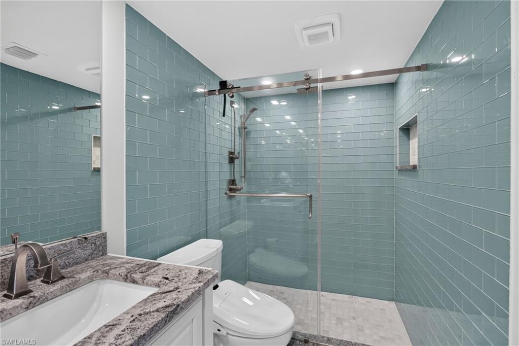 Beautiful sea glass tile work, heavy shower doors