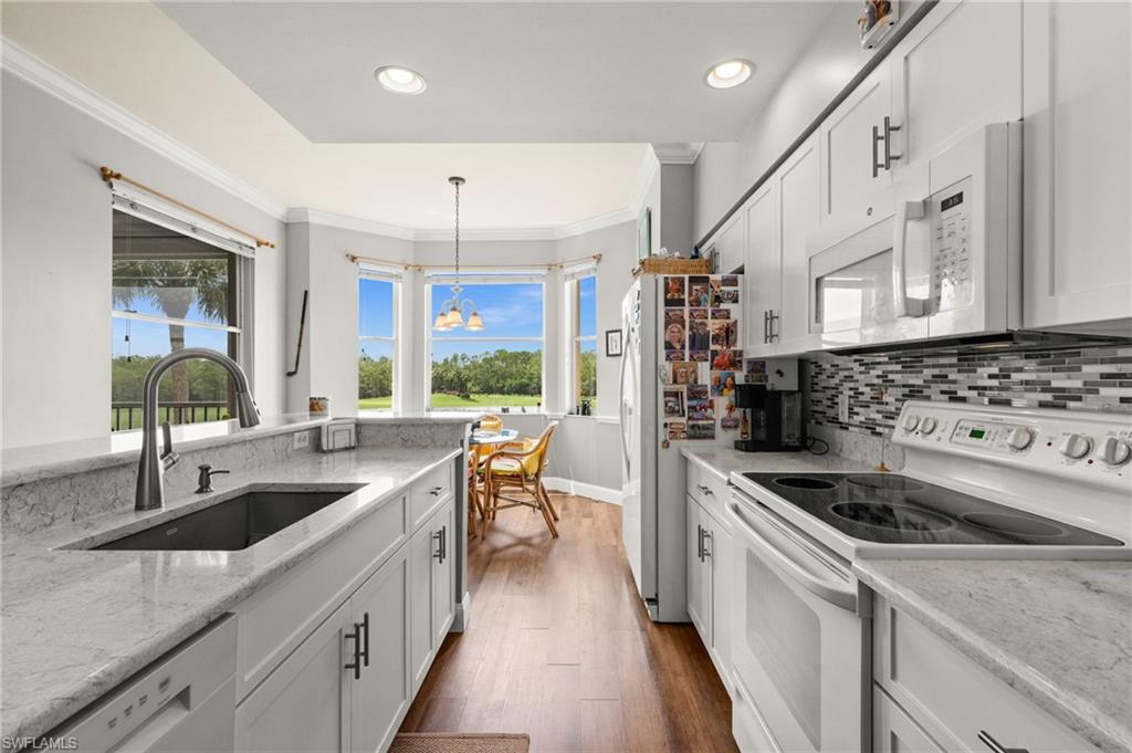 Modern kitchen with white cabinetry and light-toned countertops