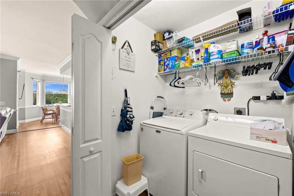 Dedicated laundry space with white walls and built-in wire shelving