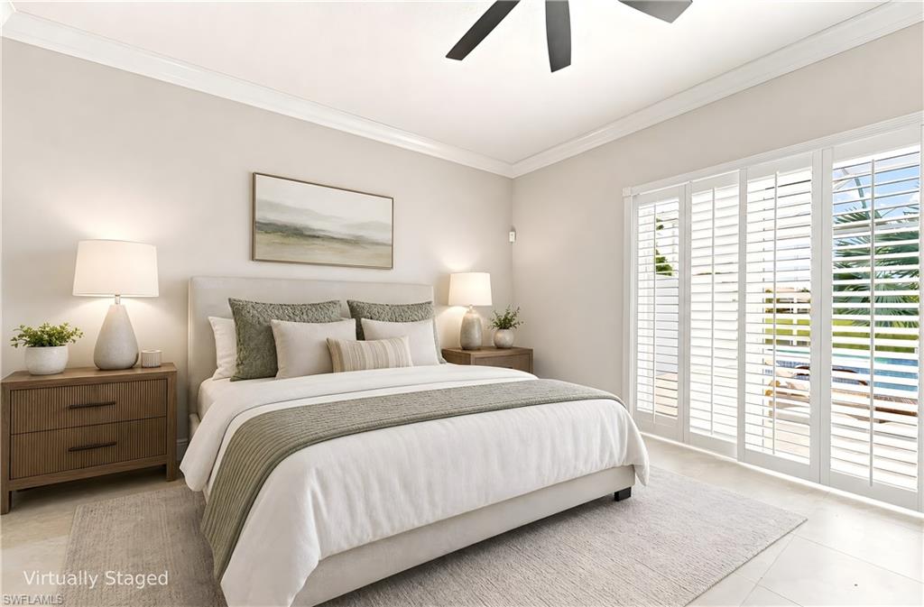 Virtually staged Master Bedroom with access to screened-in Pool deck