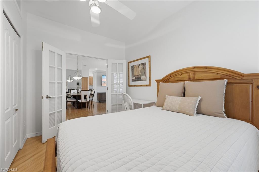 The versatile second bedroom features elegant French glass doors with Hunter Douglas blinds for privacy, beautiful plantation shutters, abundant natural light, and two closets for exceptional storage. This flexible space is ideal as a guest suite or a sophisticated home office tailored to your lifestyle needs.
