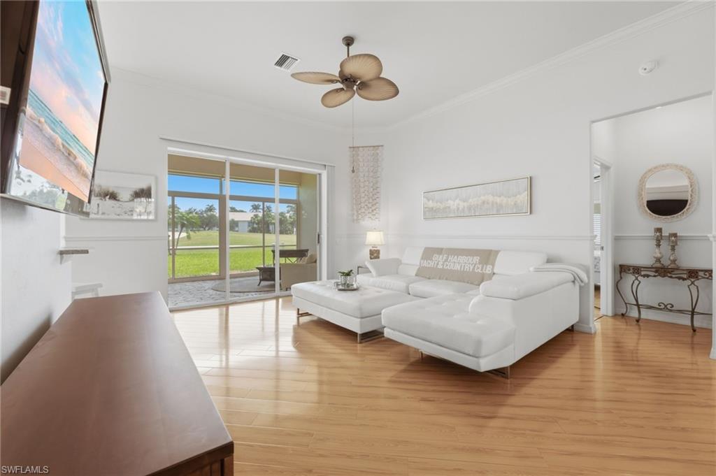 Enjoy picturesque golf course views enhanced by dramatic soaring ceilings, beautiful luxury vinyl flooring, sun-filled living spaces, designer-appointed furnishings, and exquisite crown molding.