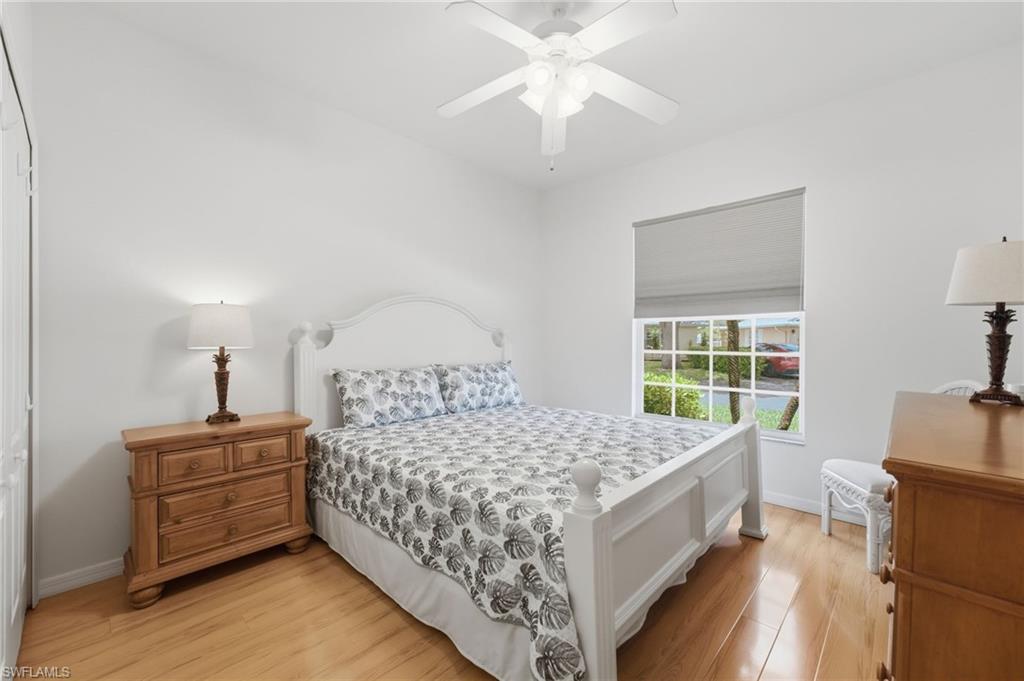 The inviting third bedroom features elegant Hunter Douglas shades, an abundance of natural light, and a comfortable retreat designed for guests, family, or flexible living needs.