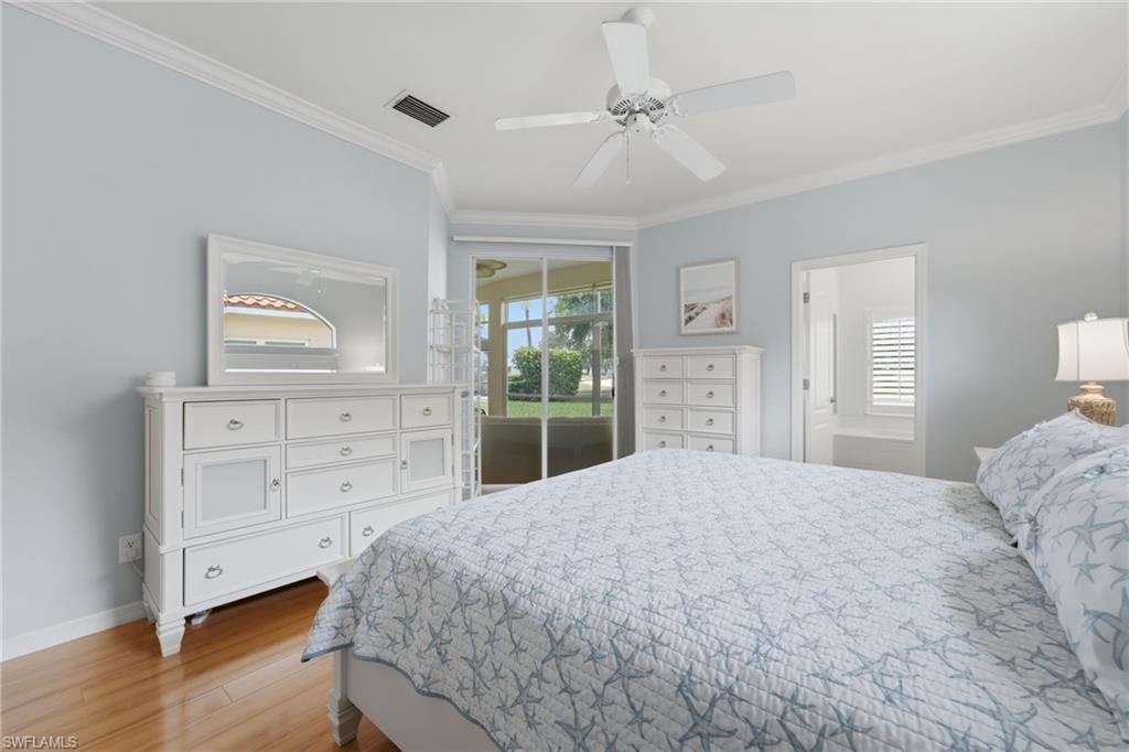 The luxurious primary suite offers private lanai access, a spacious walk-in closet, and a beautifully appointed ensuite bath, while abundant natural light fills the space, creating a serene and inviting retreat.