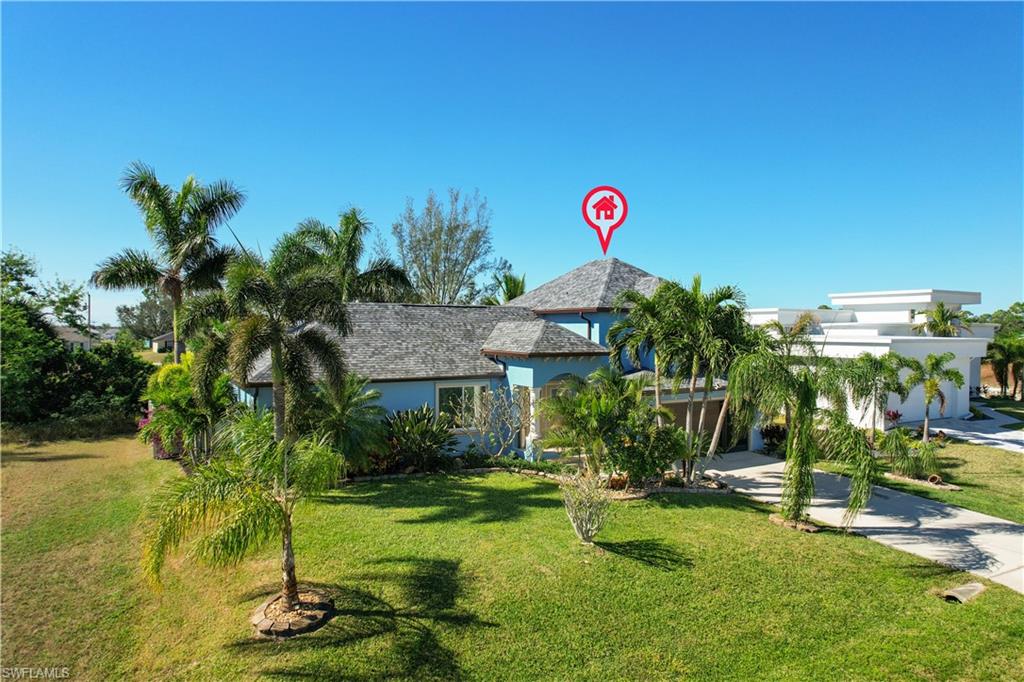 Expansive lawn featuring mature palm trees and established landscaping