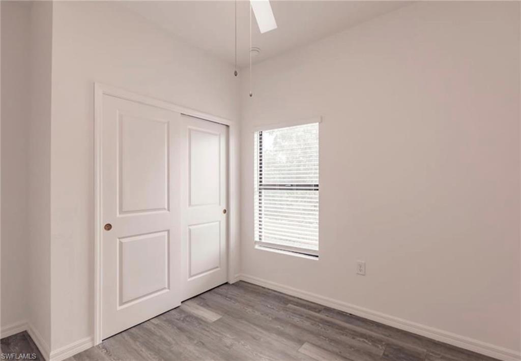 Room featuring light gray wood-finish flooring and white walls