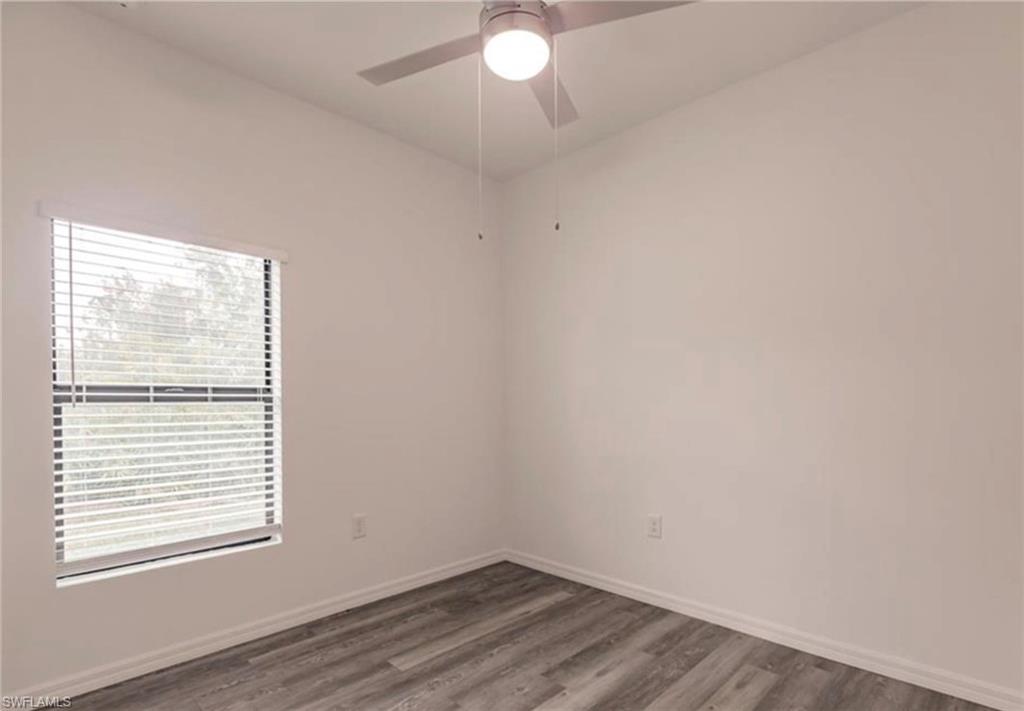 Neutral wall tones complemented by wood-finish flooring