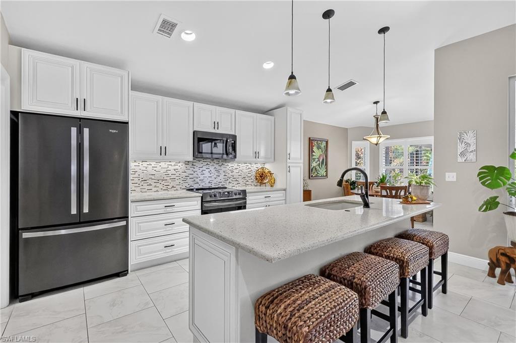 Remodeled Kitchen with quartz countertops and breakfast bar.