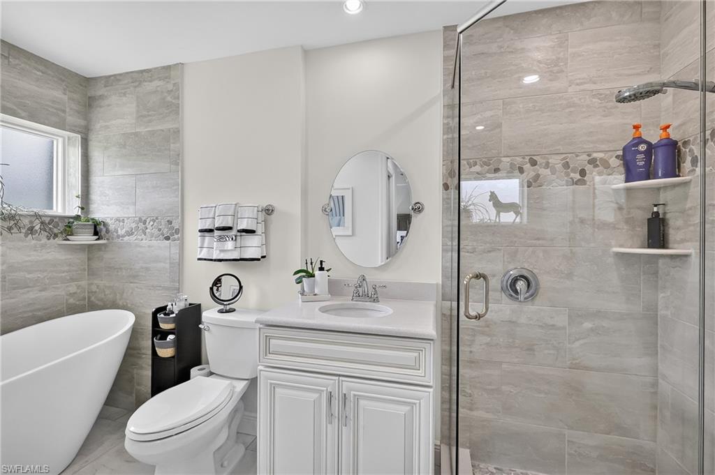 Remodeled Primary Bathroom with soaking tub, separate shower, and quartz vanity top.