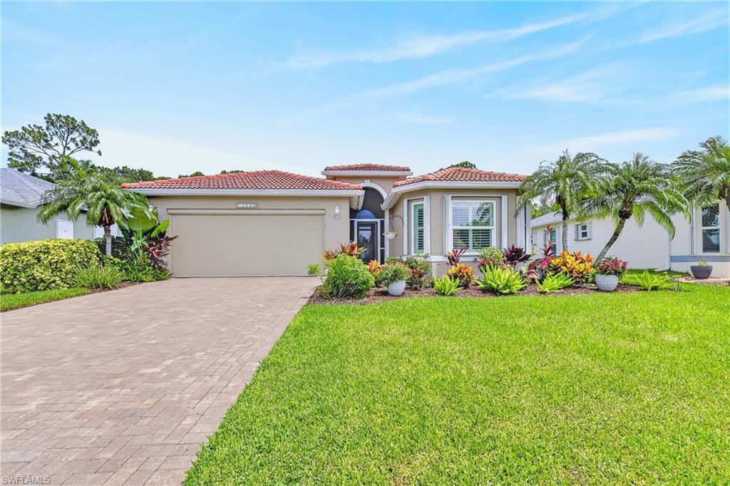 Beautiful front yard and paver driveway.