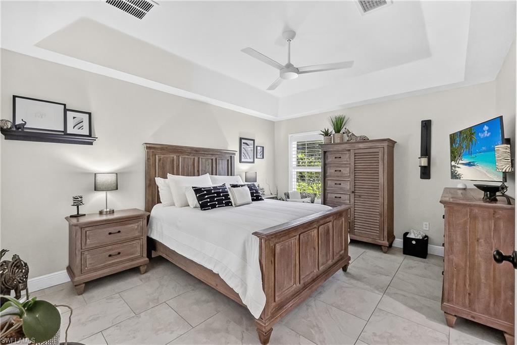 Large Primary Bedroom with sliding glass doors to the pool lanai.