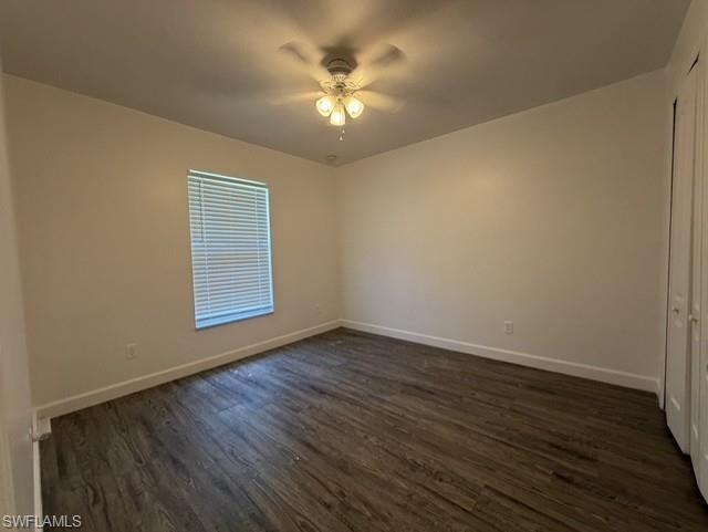 Room featuring wood-finish flooring, a window with horizontal blinds, and a ceiling fan with integrated lighting