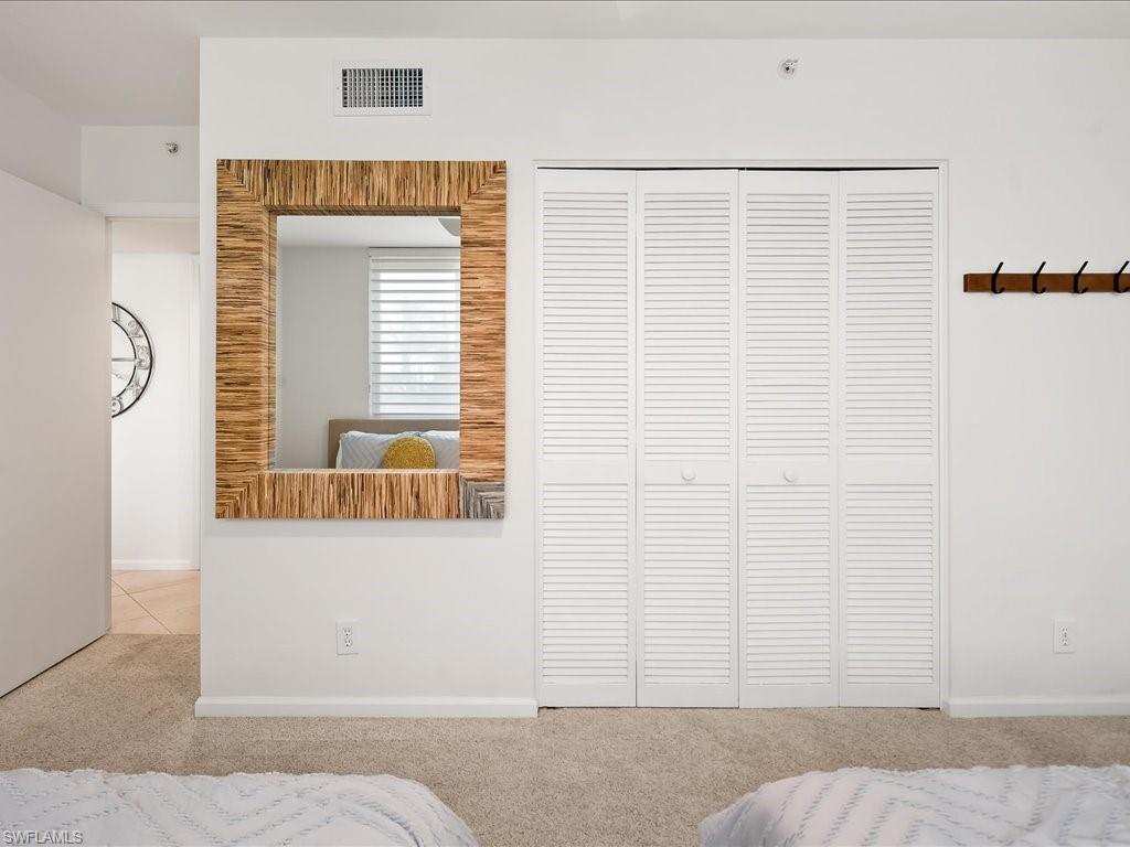 White louvered bifold closet doors with circular pulls