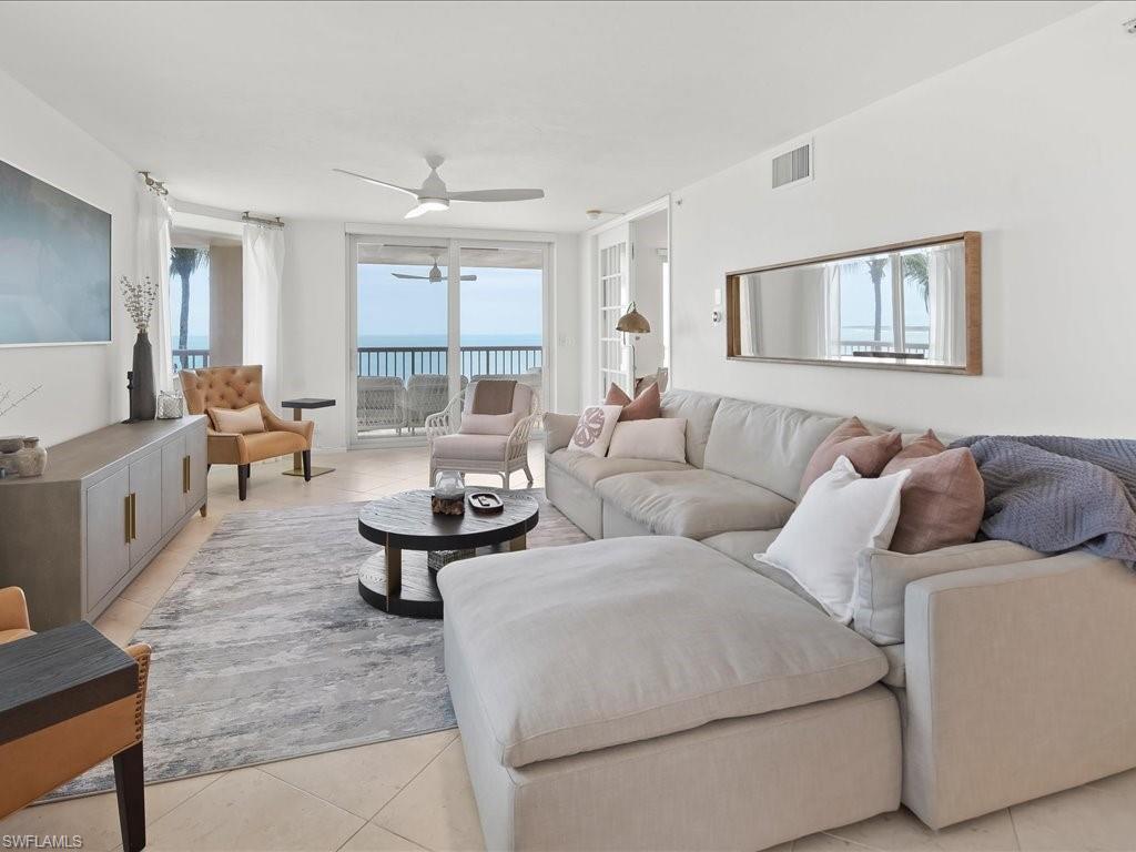 Living area with light tile flooring and white walls