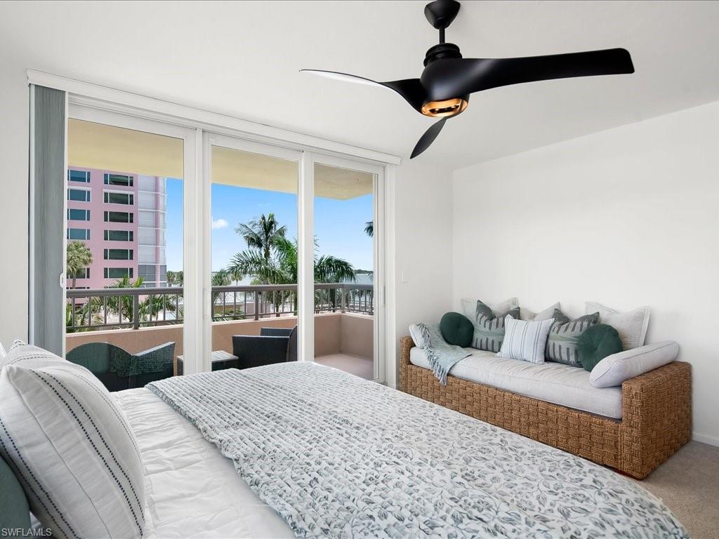 Floor-to-ceiling glass doors opening onto an outdoor balcony