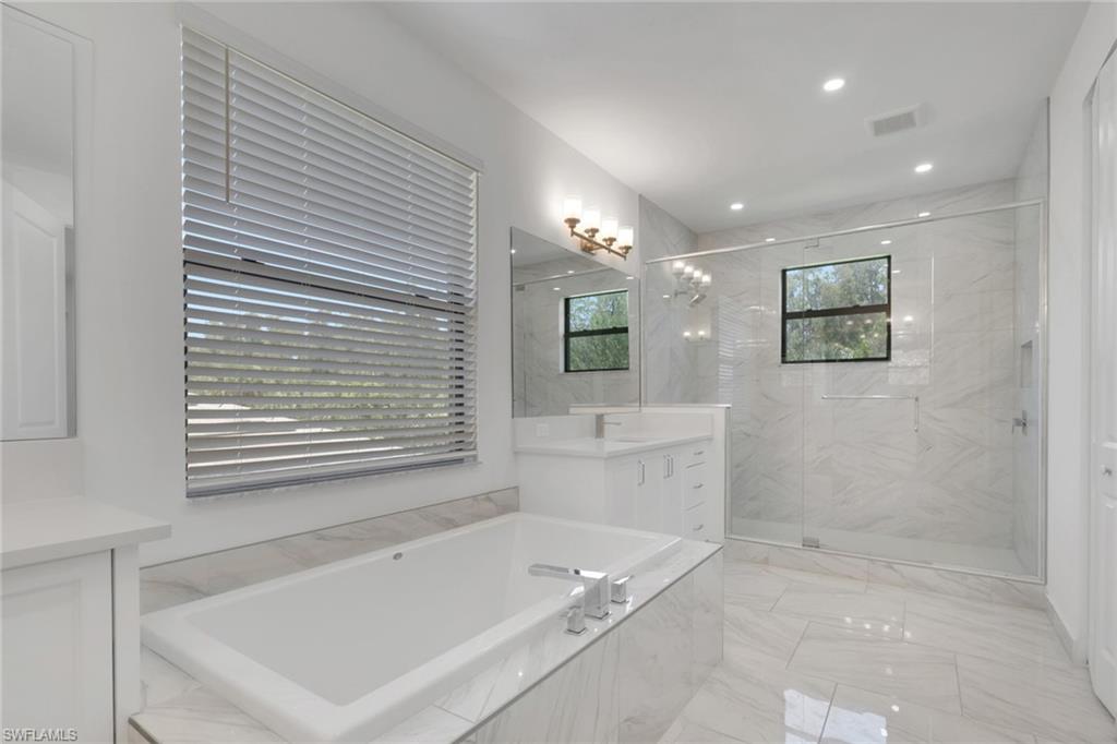 Primary bath features Roman tub and separate shower.