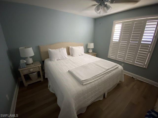 Bedroom with dark wood-style floors and a ceiling fan