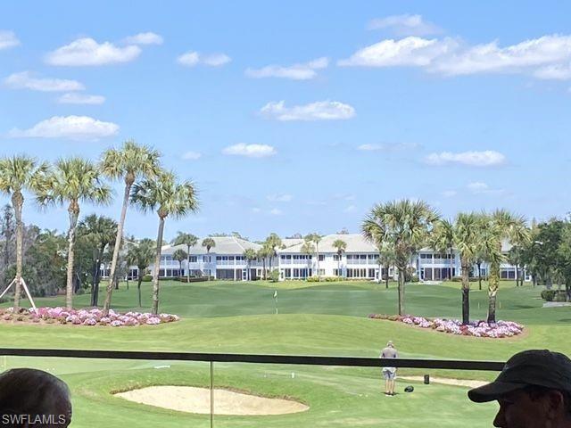 View of home's community with golf course view and a lawn