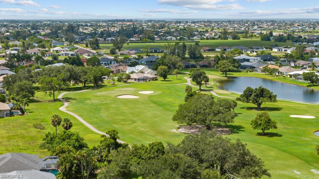 Expansive golf course and water feature, bordered by residential properties