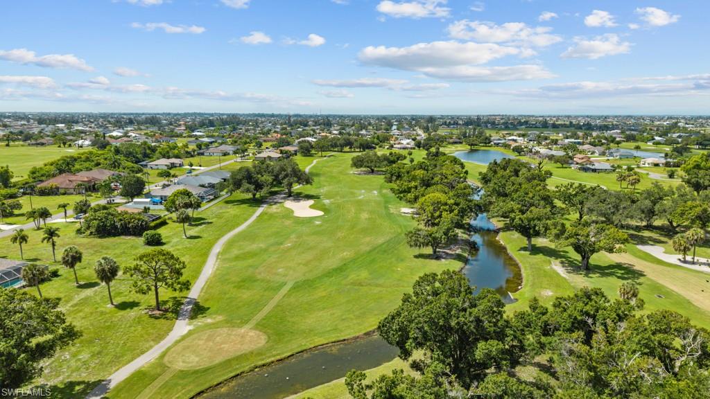 Expansive golf course featuring manicured fairways, sand traps, and natural waterways