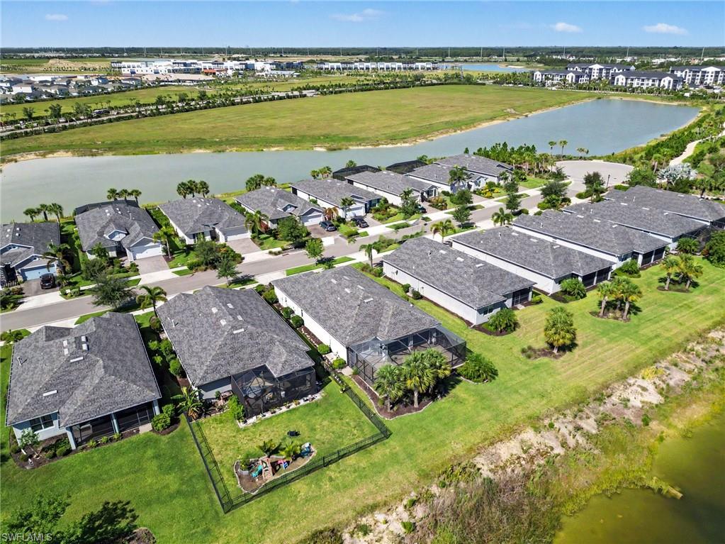 Aerial perspective showcasing multiple properties featuring screened lanais and landscaped grounds