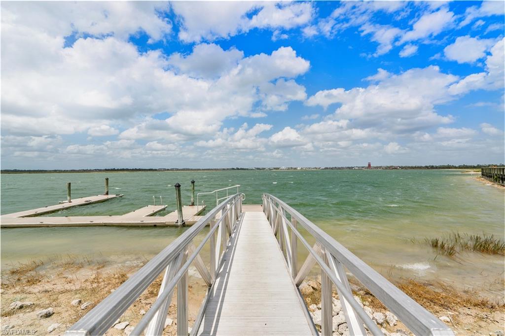 Private boat dock with multiple slips, featuring an aluminum ramp and handrails