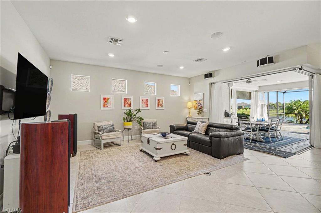 Spacious interior featuring large format tile flooring, recessed lighting, and a neutral wall palette