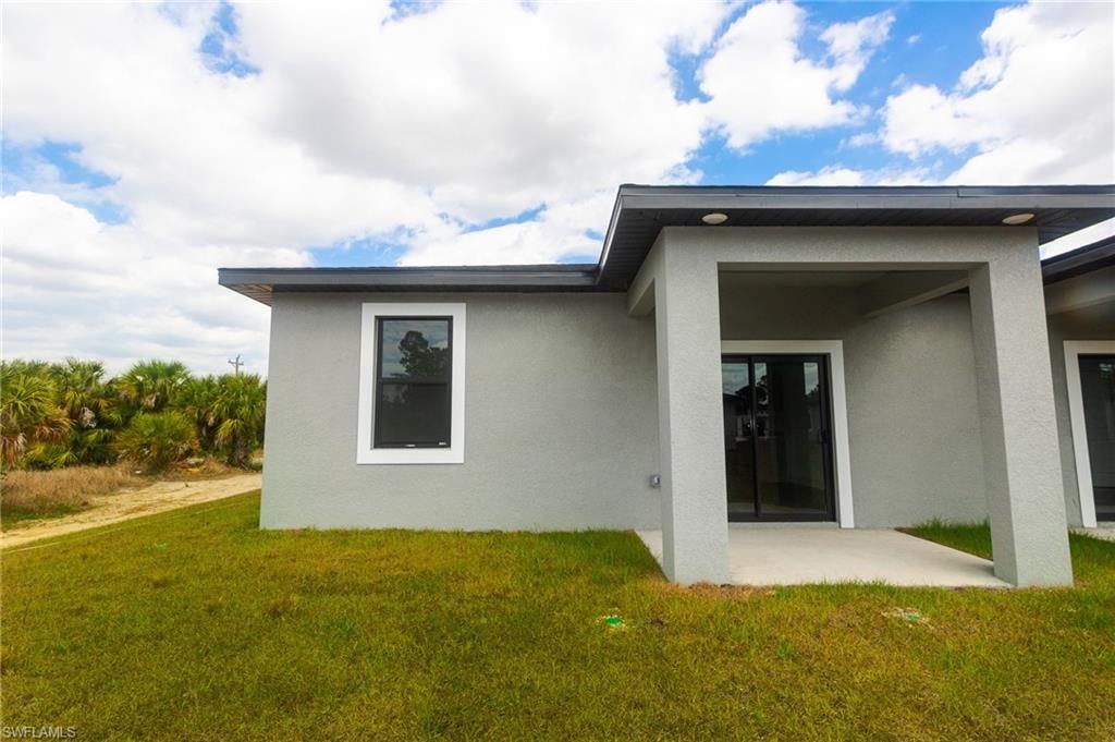 Contemporary exterior featuring stucco siding and dark trim