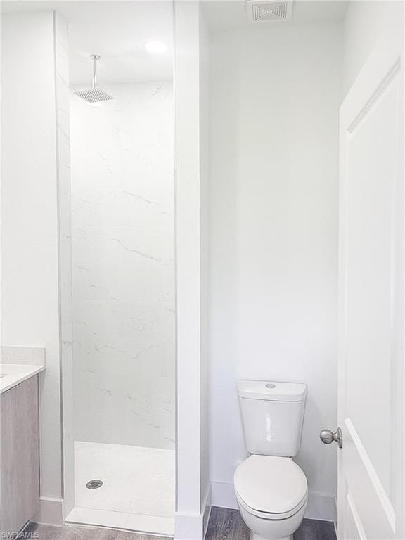 Walk-in shower featuring a rainfall showerhead, white marble-look wall tiles, and a white shower pan