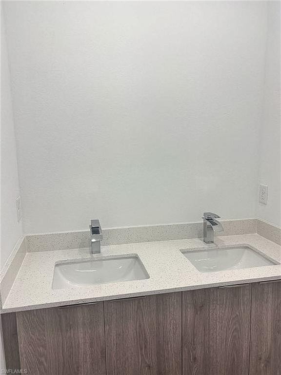 Dual integrated sinks with chrome faucets set into a speckled countertop