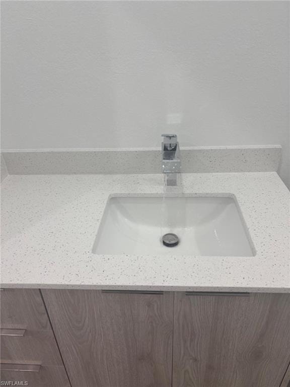 Light-toned wood-finish vanity with an integrated rectangular sink
