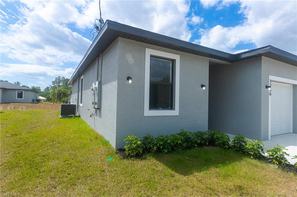 Contemporary gray stucco exterior with white trim accents