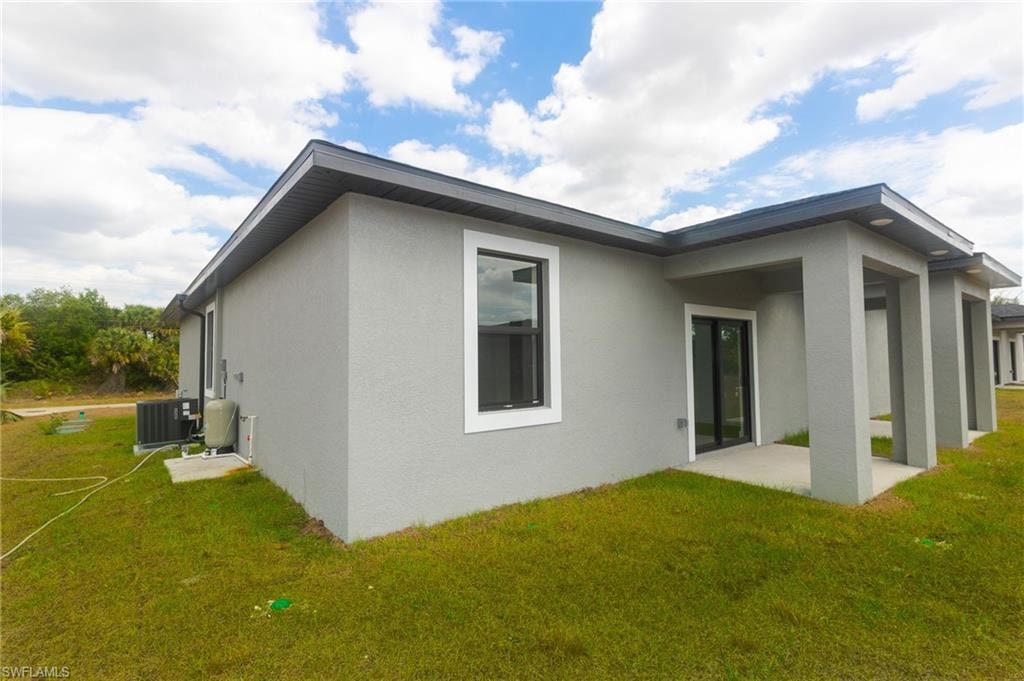 Contemporary exterior featuring gray stucco, white trim, and a dark fascia