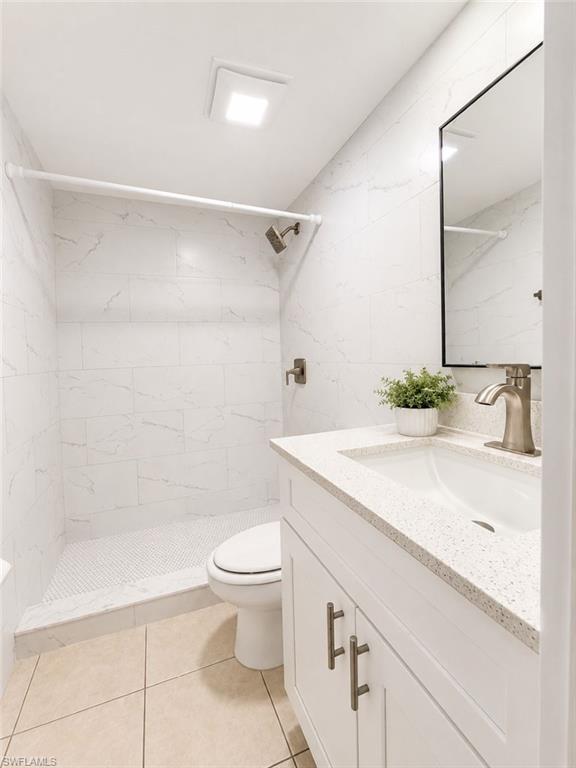 PRIMARY Bathroom featuring a white vanity with a speckled countertop, undermount sink, and brushed nickel faucet