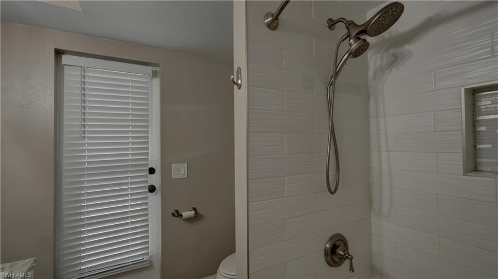 Shower featuring a dual shower head system with a handheld sprayer and brushed nickel fixtures